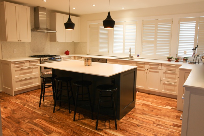 A two tone - white and grey - kitchen featuring a custom made wide rail shaker door fit on IKEA Akurum cabinets